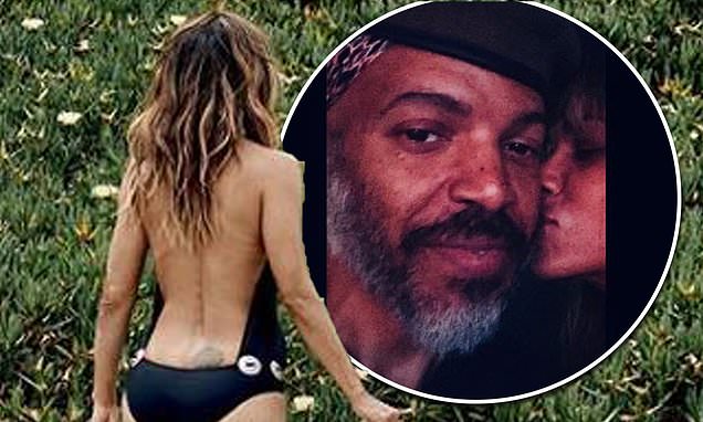 Halle Berry, 54, shows off her age-defying physique in a backless black swimsuit – Daily Mail