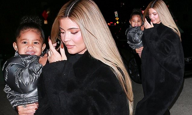 Kylie Jenner cradles Stormi, two, and wraps up in warm black coat as she steps out in Santa Monica – Daily Mail