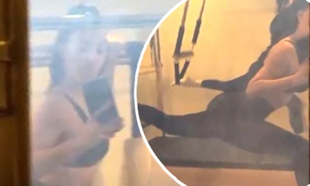 Kim Kardashian wows in spandex and a sports bra as she performs the splits – Daily Mail