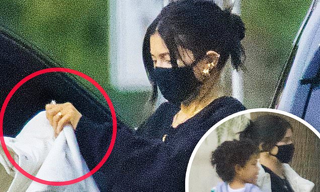 Kylie Jenner fuels marriage rumors as she flashes diamond band before flight with daughter Stormi – Daily Mail