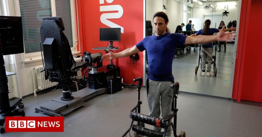 Paralysed man with severed spine walks thanks to implant – BBC News