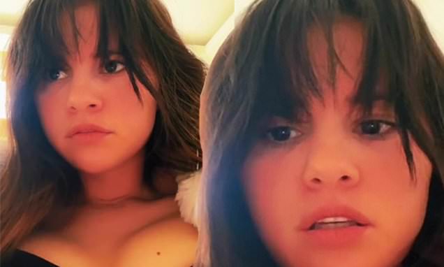 Selena Gomez pokes fun at her love life as she puts her cleavage and bangs on display in video – Daily Mail